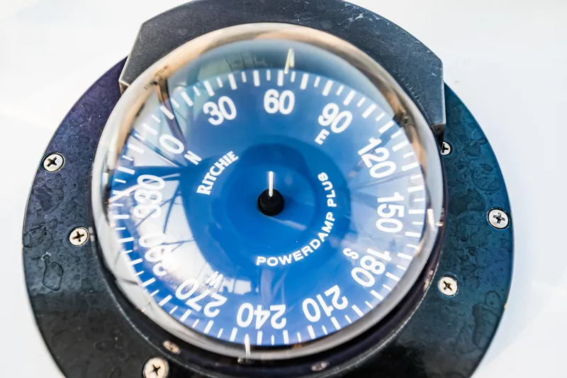Leslie Ann Yacht Photos Pics Compass on 1988 Buddy Davis 47 Convertible boat, displaying cardinal directions.
