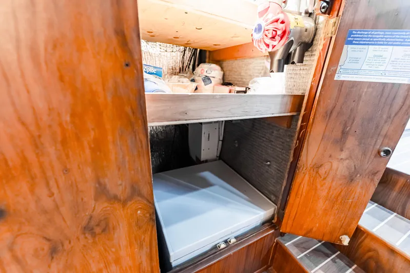 Leslie Ann Yacht Photos Pics 1988 Buddy Davis 47 Convertible interior storage with wooden cabinetry and equipment.