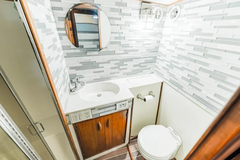 Leslie Ann Yacht Photos Pics Bathroom interior of 1988 Buddy Davis 47 Convertible yacht with modern fixtures and wood accents.