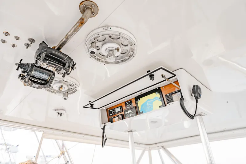 Leslie Ann Yacht Photos Pics 1988 Buddy Davis 47 Convertible boat interior with fishing reels and navigation equipment.