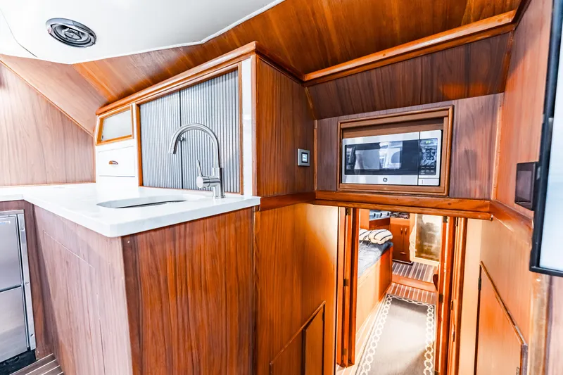 Leslie Ann Yacht Photos Pics Interior of 1988 Buddy Davis 47 Convertible yacht with wood finish and modern amenities.