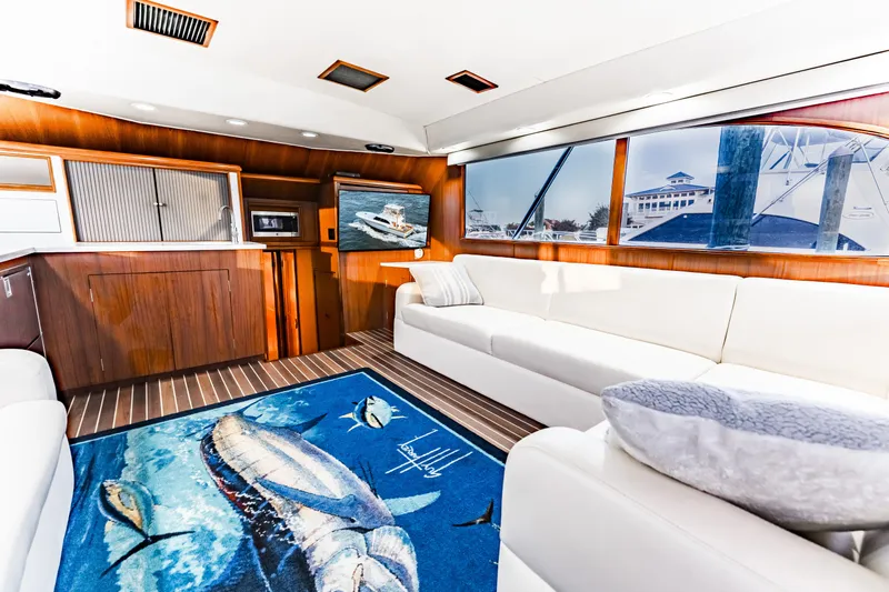 Leslie Ann Yacht Photos Pics Luxurious interior of 1988 Buddy Davis 47 Convertible yacht with plush seating and marine-themed decor.