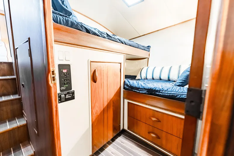 Leslie Ann Yacht Photos Pics 1988 Buddy Davis 47 Convertible cabin interior with wooden bunk beds and storage.