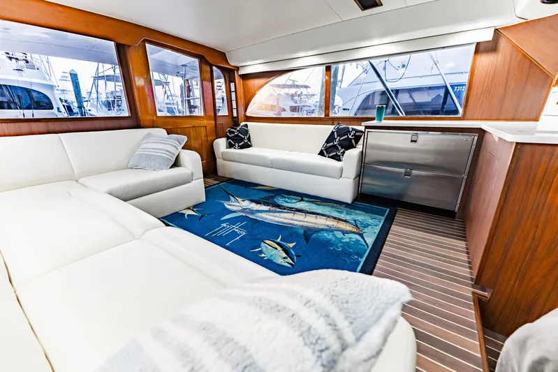 Leslie Ann Yacht Photos Pics Luxurious interior of 1988 Buddy Davis 47 Convertible yacht with white sofas and marine-themed decor.