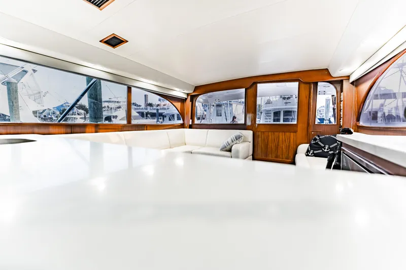 Leslie Ann Yacht Photos Pics Interior of 1988 Buddy Davis 47 Convertible yacht with white seating and wooden accents.