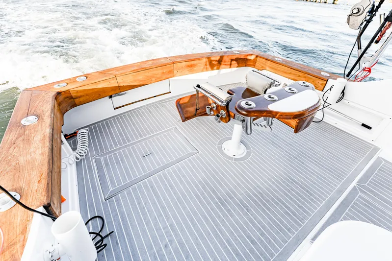 Leslie Ann Yacht Photos Pics 1988 Buddy Davis 47 Convertible boat deck with wooden trim and fishing chair.