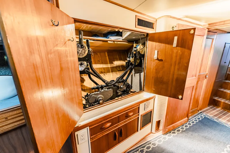 Leslie Ann Yacht Photos Pics Interior of 1988 Buddy Davis 47 Convertible yacht showing open wooden cabinet with mechanical components.