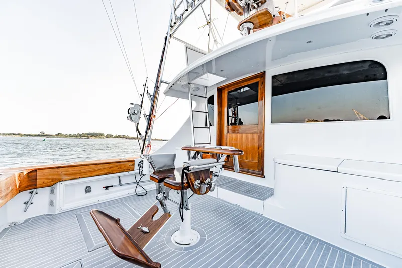 Leslie Ann Yacht Photos Pics 1988 Buddy Davis 47 Convertible yacht deck with fishing chair, wooden accents, and ocean view.