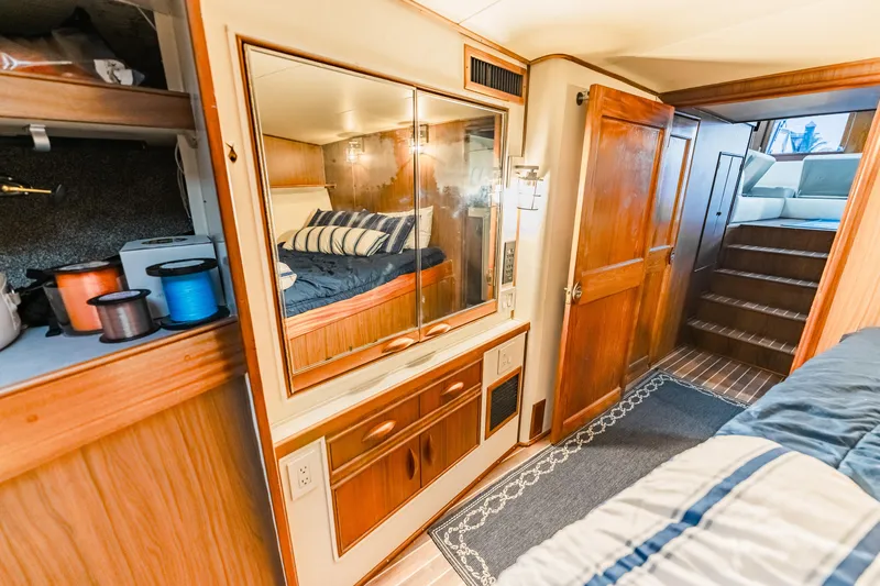 Leslie Ann Yacht Photos Pics Interior of 1988 Buddy Davis 47 Convertible yacht with wooden cabinetry and cozy bedroom.