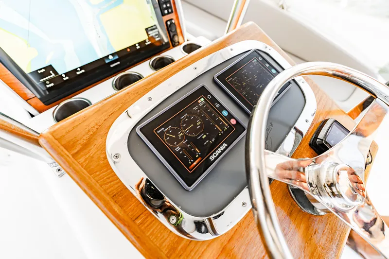 Leslie Ann Yacht Photos Pics Control panel of a 1988 Buddy Davis 47 Convertible yacht with modern navigation displays.