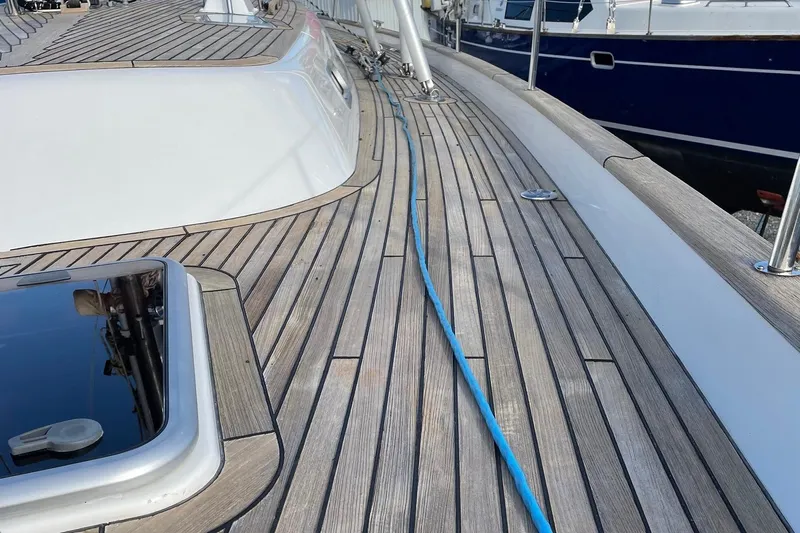 Friheten Yacht Photos Pics Teak deck of 2009 Hallberg-Rassy 54 yacht with blue rope and sleek design.