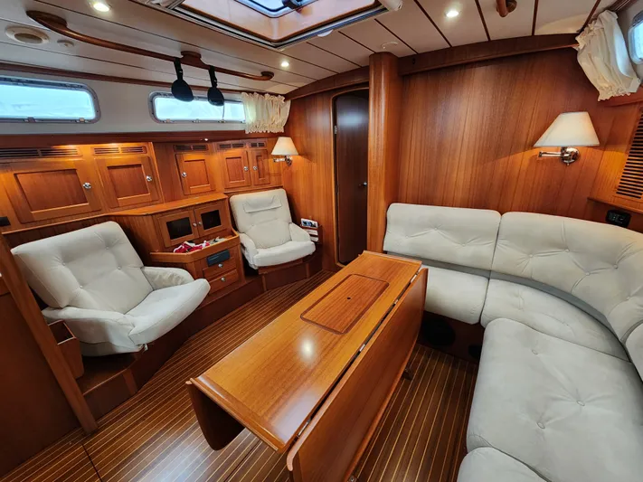 Friheten Yacht Photos Pics Luxurious 2009 Hallberg-Rassy 54 yacht interior with elegant wood finish and comfortable seating.