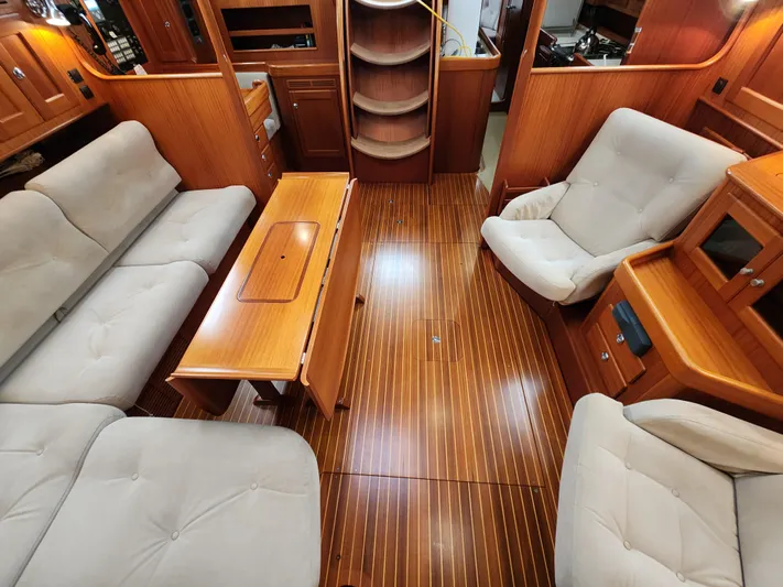 Friheten Yacht Photos Pics Luxurious 2009 Hallberg-Rassy 54 yacht interior with plush seating and elegant wood finish.