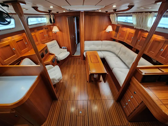 Friheten Yacht Photos Pics Luxurious 2009 Hallberg-Rassy 54 yacht interior with elegant wood finish and comfortable seating.