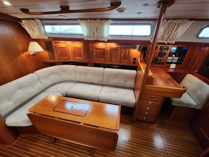Friheten Yacht Photos Pics Luxurious 2009 Hallberg-Rassy 54 yacht interior with plush seating and elegant wood finishes.