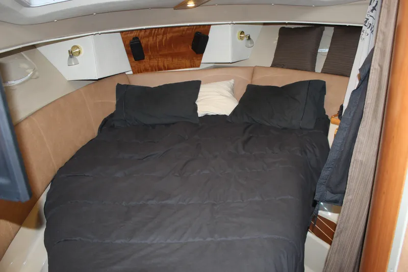  Yacht Photos Pics Cozy cabin interior of 2016 Cutwater 30 Command Bridge with comfortable bedding.