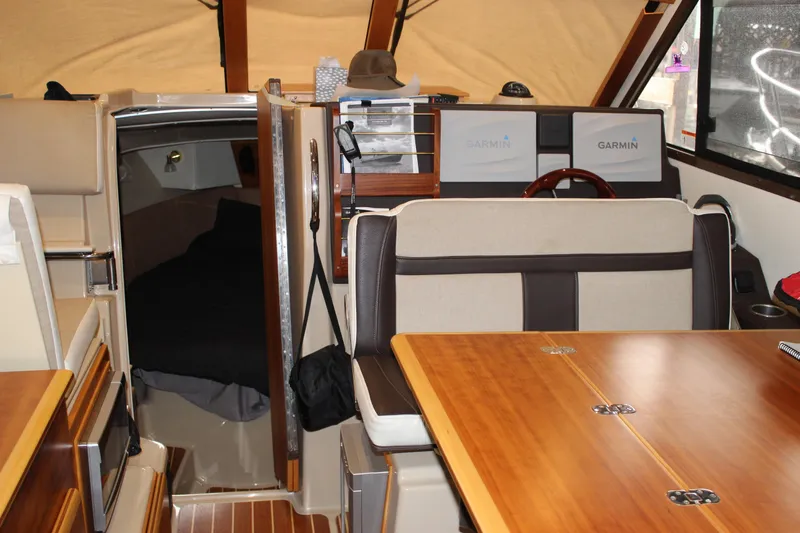  Yacht Photos Pics Interior of 2016 Cutwater 30 Command Bridge with wood accents and Garmin navigation.