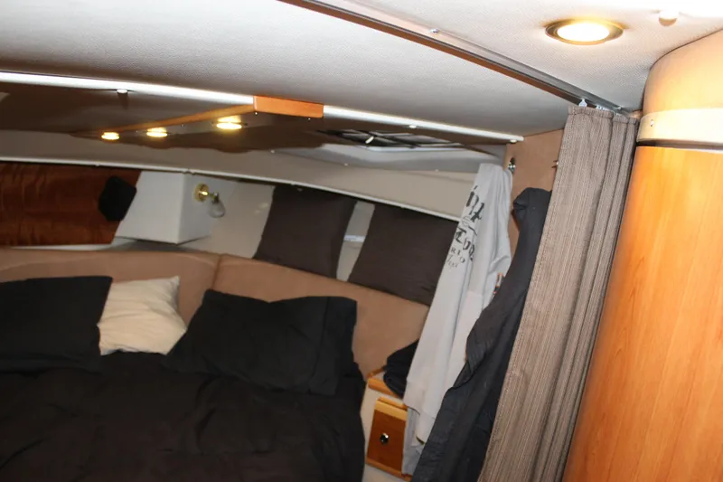  Yacht Photos Pics Interior cabin of 2016 Cutwater 30 Command Bridge with cozy bedding and ambient lighting.