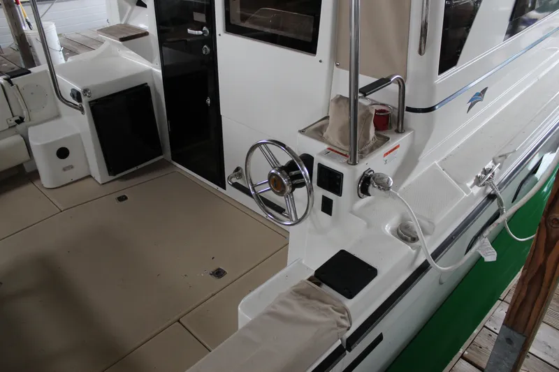  Yacht Photos Pics 2016 Cutwater 30 Command Bridge boat interior with steering wheel and deck details.