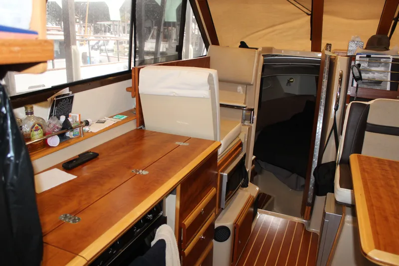  Yacht Photos Pics 2016 Cutwater 30 Command Bridge interior with wood finish and cozy cabin space.