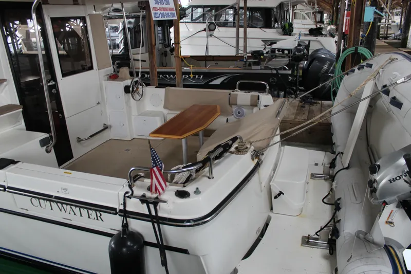  Yacht Photos Pics 2016 Cutwater 30 Command Bridge boat docked, featuring a spacious deck and seating area.