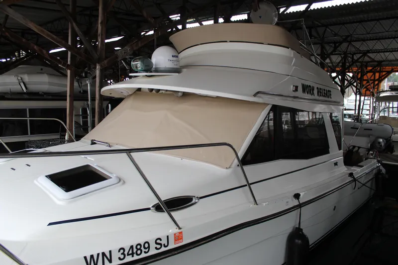  Yacht Photos Pics 2016 Cutwater 30 Command Bridge boat docked in a covered marina.
