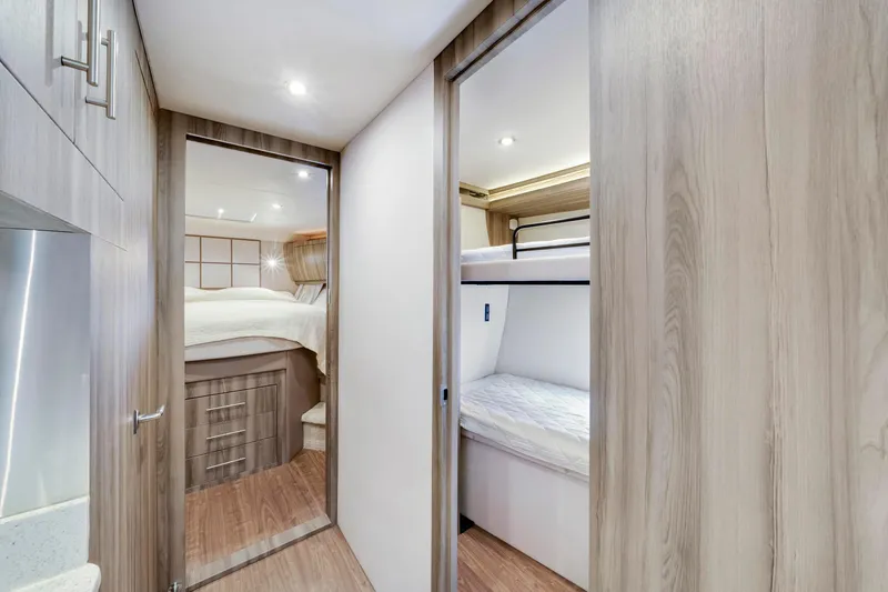 Life Is Good Yacht Photos Pics Interior of 2017 Regal 53 Sport Coupe with bunk beds and modern wood finish.