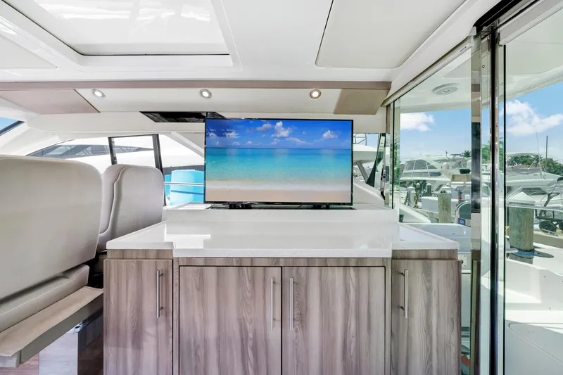 Life Is Good Yacht Photos Pics Interior of 2017 Regal 53 Sport Coupe yacht with modern cabinetry and TV display.