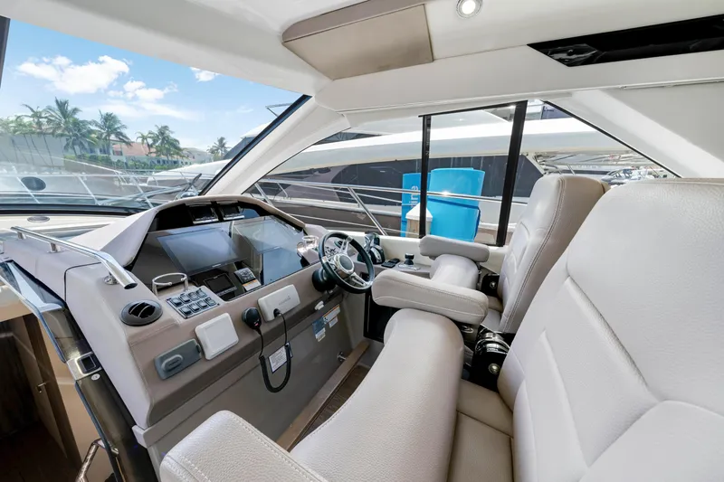 Life Is Good Yacht Photos Pics Interior of 2017 Regal 53 Sport Coupe yacht, featuring modern helm and luxurious seating.