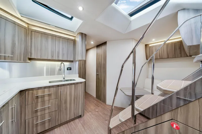 Life Is Good Yacht Photos Pics Luxurious interior of 2017 Regal 53 Sport Coupe yacht with modern kitchen and seating area.