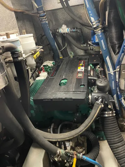 Friheten Yacht Photos Pics Engine room of a 2009 Hallberg-Rassy 54 yacht with visible components and hoses.