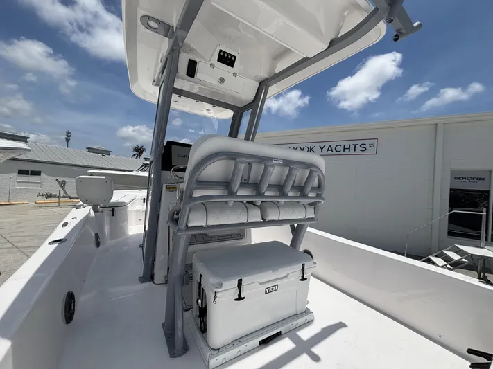  Yacht Photos Pics 2025 Sea Fox 251 Bay Fox boat interior with seating and cooler, docked at a marina.