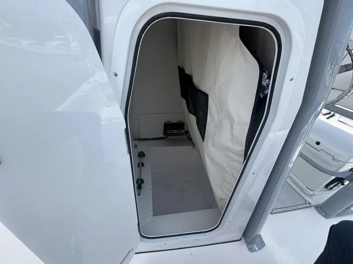  Yacht Photos Pics 2025 Sea Fox 251 Bay Fox interior storage compartment with open door.