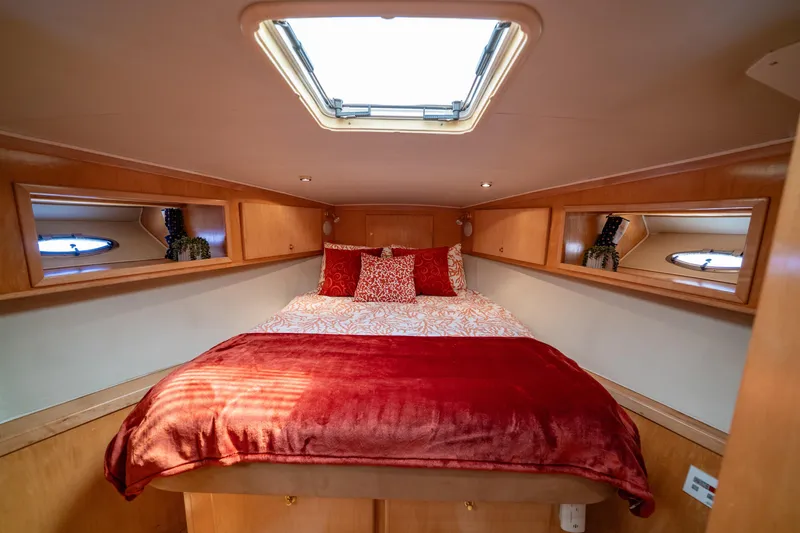 Altitude Adjustment Yacht Photos Pics Cozy bedroom in 2000 Navigator 5300 Classic yacht with skylight and red bedding.