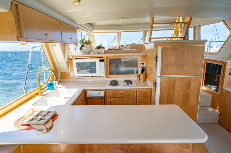 Altitude Adjustment Yacht Photos Pics Luxurious kitchen interior of 2000 Navigator 5300 Classic yacht with ocean view.