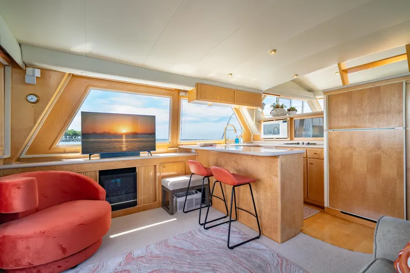 Altitude Adjustment Yacht Photos Pics Luxurious interior of 2000 Navigator 5300 Classic yacht with modern kitchen and seating area.