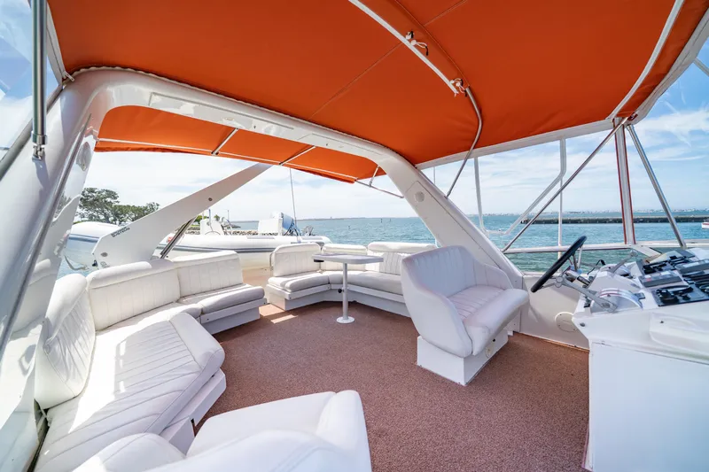 Altitude Adjustment Yacht Photos Pics Luxurious 2000 Navigator 5300 Classic yacht interior with orange canopy and white seating.