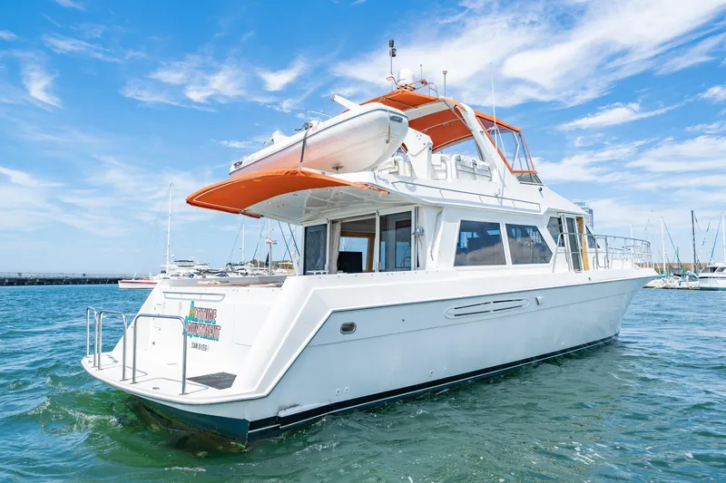 Altitude Adjustment Yacht Photos Pics 2000 Navigator 5300 Classic yacht on water, clear sky, marina background.