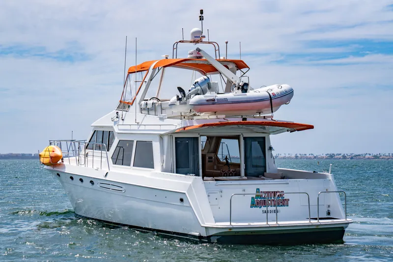 Altitude Adjustment Yacht Photos Pics Navigator 5300 Classic yacht from 2000 on open water, featuring an orange canopy.