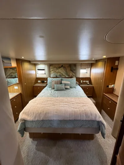 Our Time Yacht Photos Pics Luxurious bedroom in 2001 Bayliner 5788 Pilot House Motoryacht with elegant bedding and wood accents.