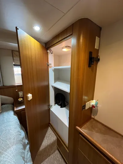 Our Time Yacht Photos Pics Interior of 2001 Bayliner 5788 Pilot House Motoryacht with open wooden closet.