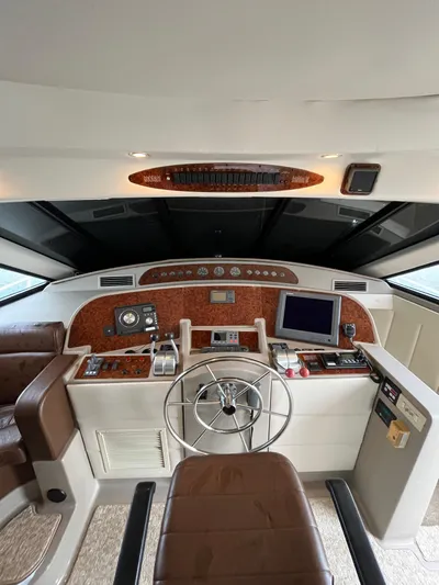 Our Time Yacht Photos Pics 2001 Bayliner 5788 Pilot House Motoryacht helm with steering wheel, controls, and navigation equipment.