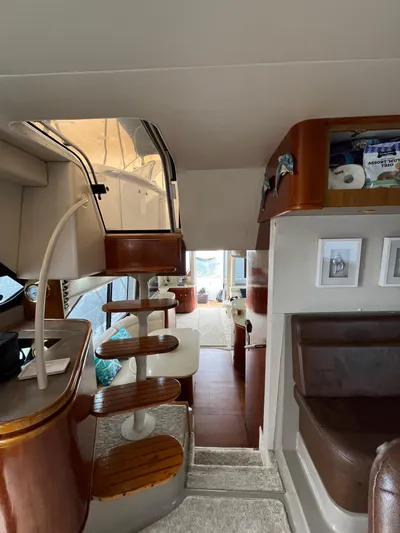 Our Time Yacht Photos Pics Interior of 2001 Bayliner 5788 Pilot House Motoryacht with wooden stairs and seating area.