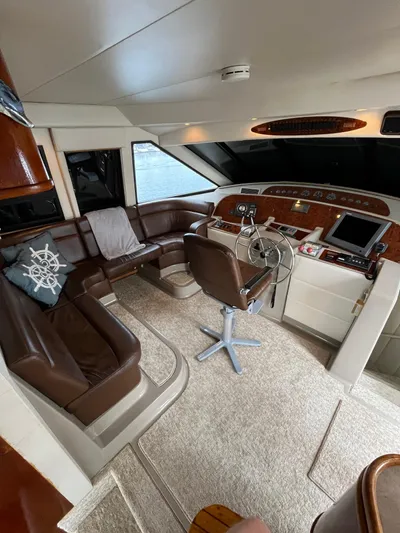 Our Time Yacht Photos Pics Interior of 2001 Bayliner 5788 Pilot House Motoryacht with leather seating and navigation controls.