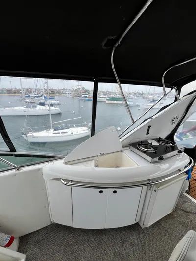 Our Time Yacht Photos Pics 2001 Bayliner 5788 Pilot House Motoryacht interior with kitchenette and marina view.