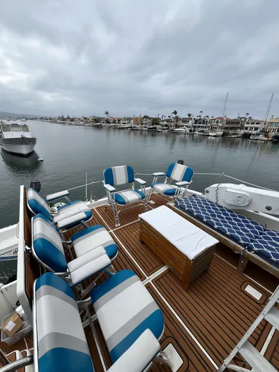 Our Time Yacht Photos Pics 2001 Bayliner 5788 Pilot House Motoryacht deck with seating, overlooking marina.