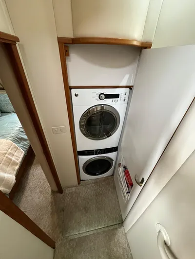 Our Time Yacht Photos Pics Stacked washer and dryer in 2001 Bayliner 5788 Pilot House Motoryacht interior.