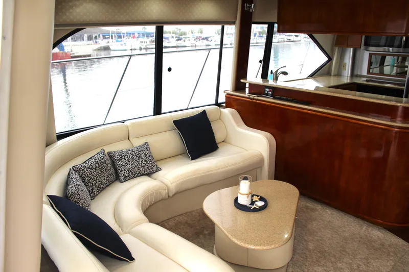 Our Time Yacht Photos Pics Luxurious interior of 2001 Bayliner 5788 Pilot House Motoryacht with elegant seating and kitchen area.