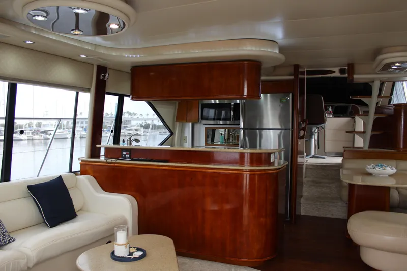 Our Time Yacht Photos Pics Luxurious interior of 2001 Bayliner 5788 Pilot House Motoryacht with modern kitchen and seating area.