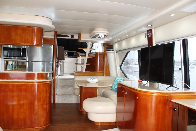 Our Time Yacht Photos Pics Luxurious interior of 2001 Bayliner 5788 Pilot House Motoryacht with modern amenities and elegant wood finish.